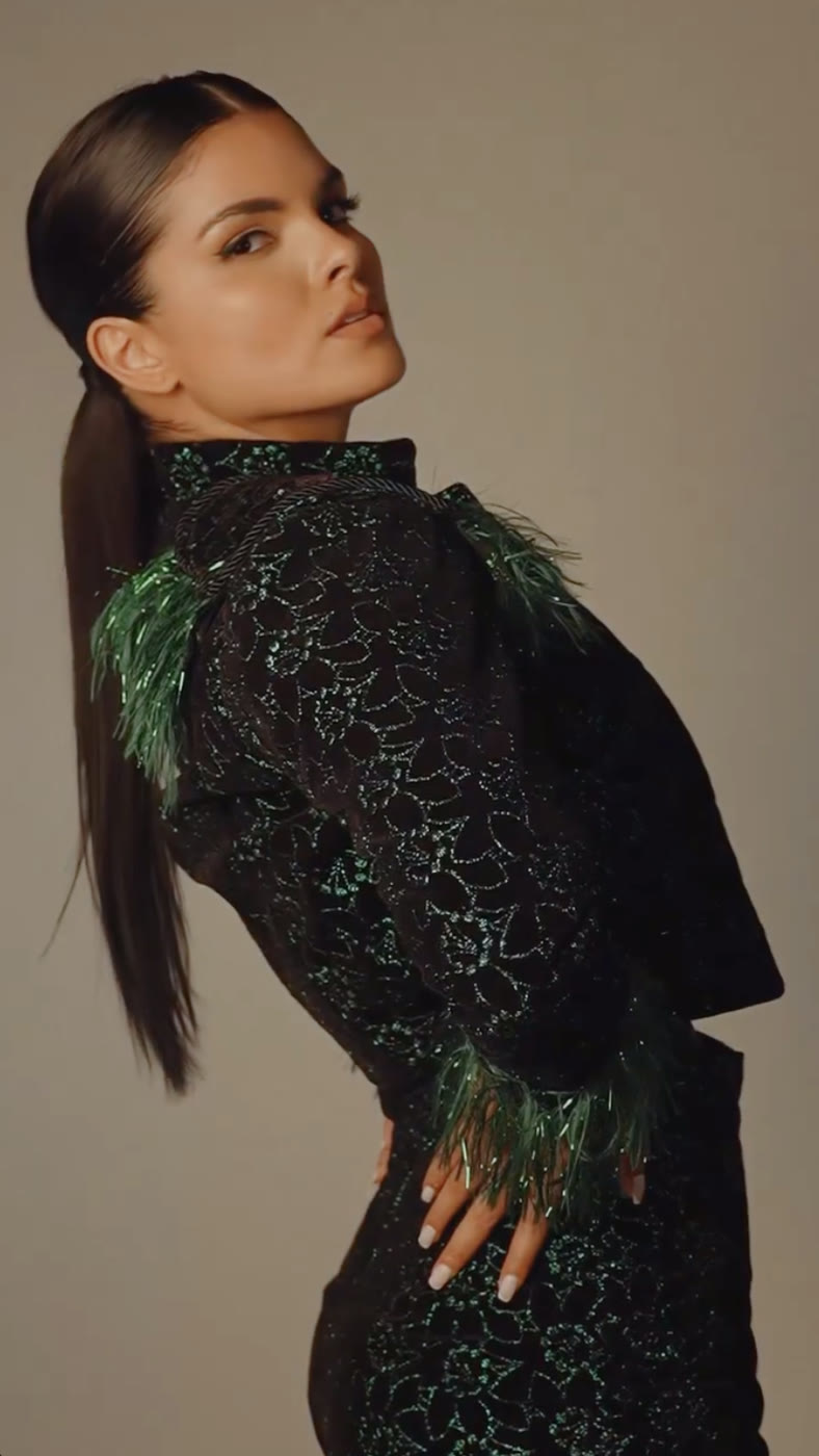 Model in a beaded, feathered Feline Atelier dress