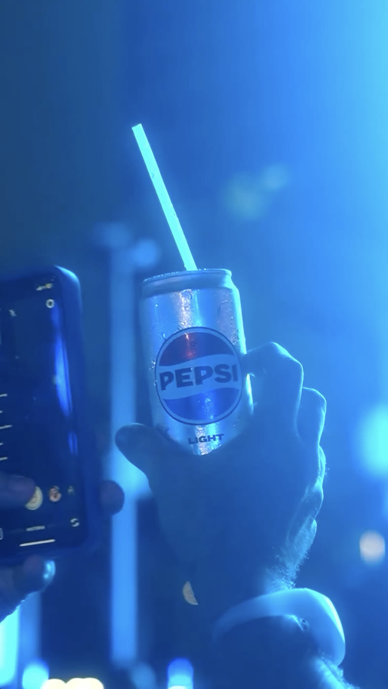Person holding a Pepsi can at the brand activation
